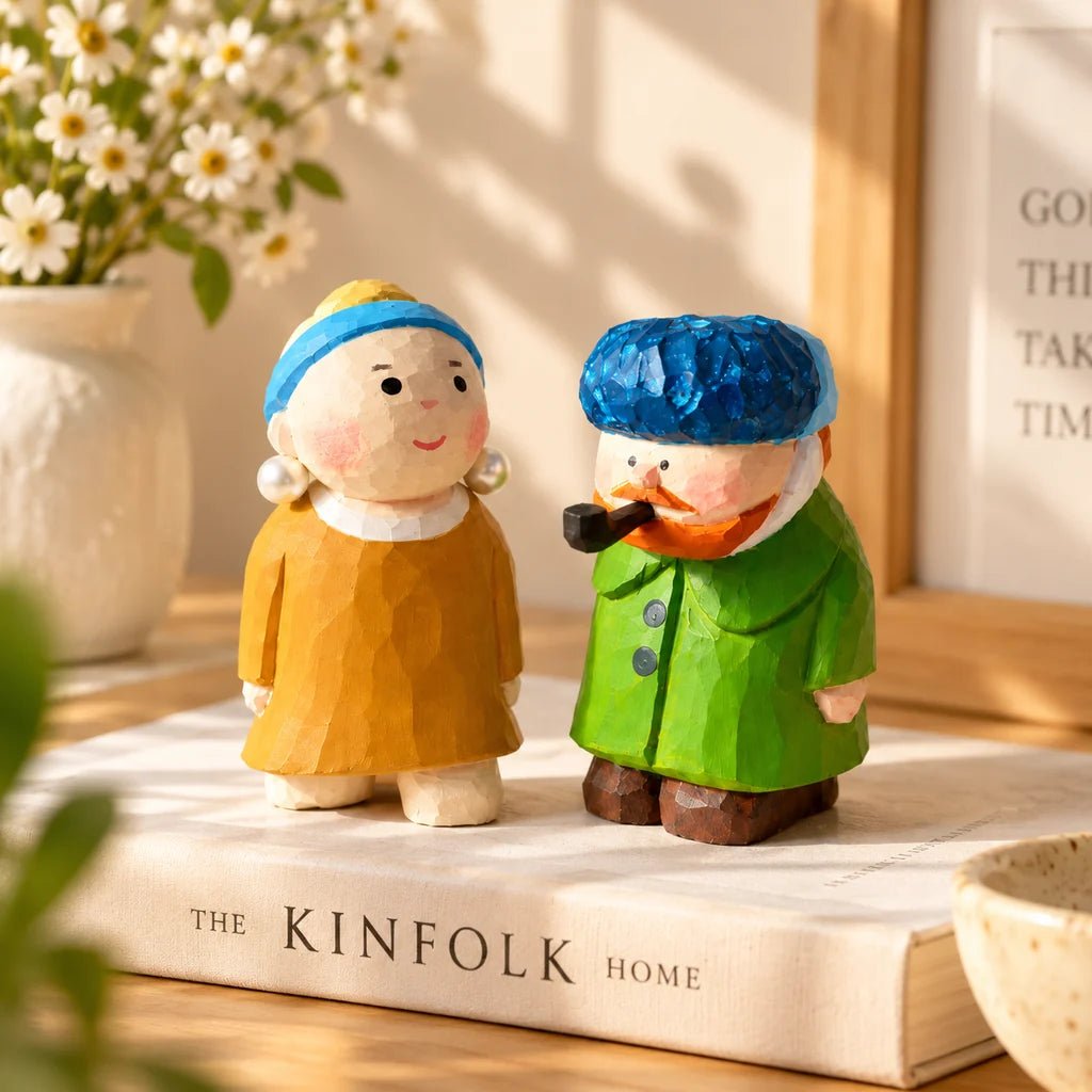 Pearl Girl and Van Gogh hand-carved wooden figurines displayed beside books and flowers as home decor