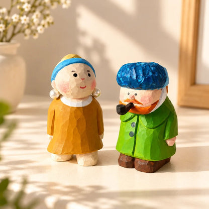 Pearl Girl and Van Gogh hand-carved wooden figurines displayed together in warm sunlight