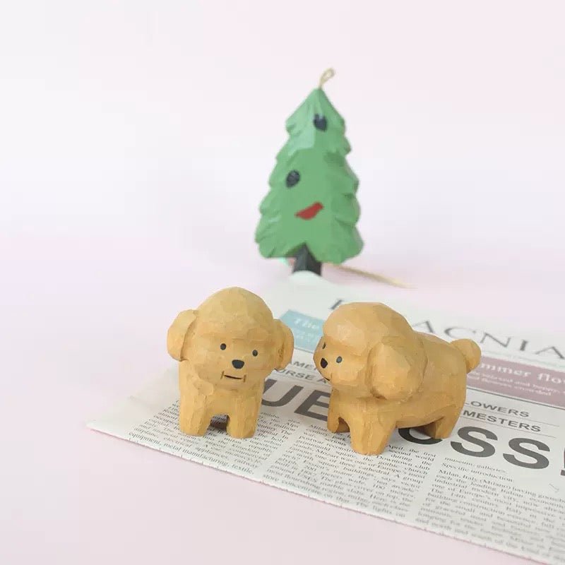 Two cute wooden figurines representing pet dogs.