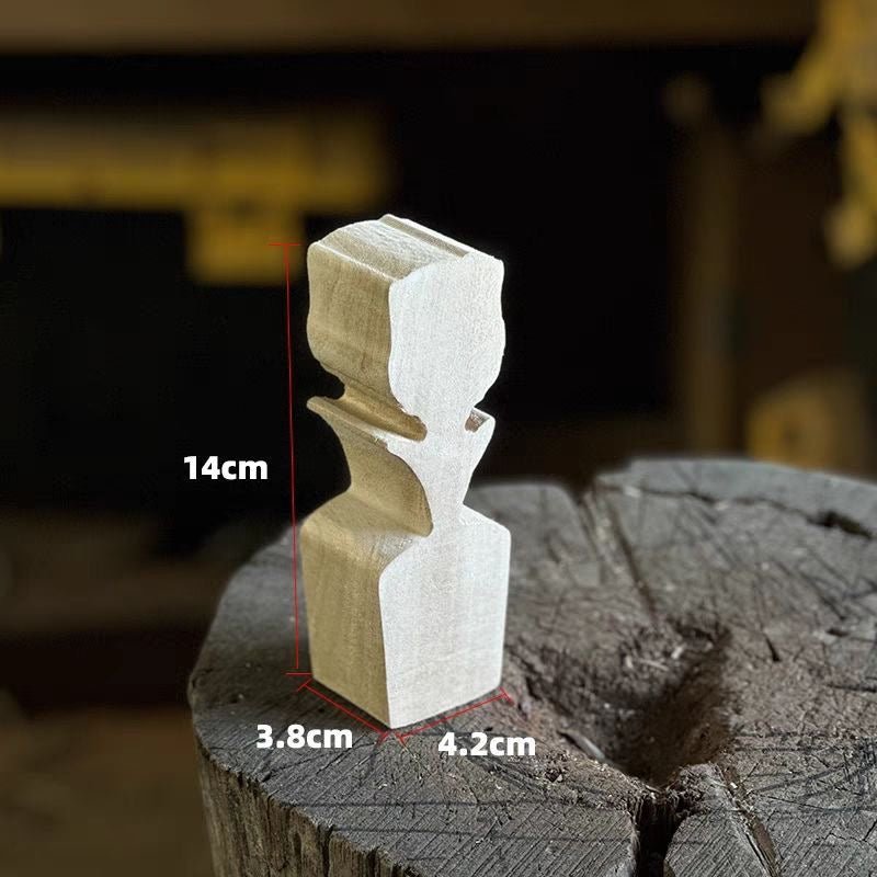 A beautifully carved wooden rose placed on a piece of wood.