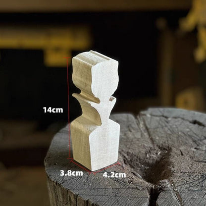 A beautifully carved wooden rose placed on a piece of wood.