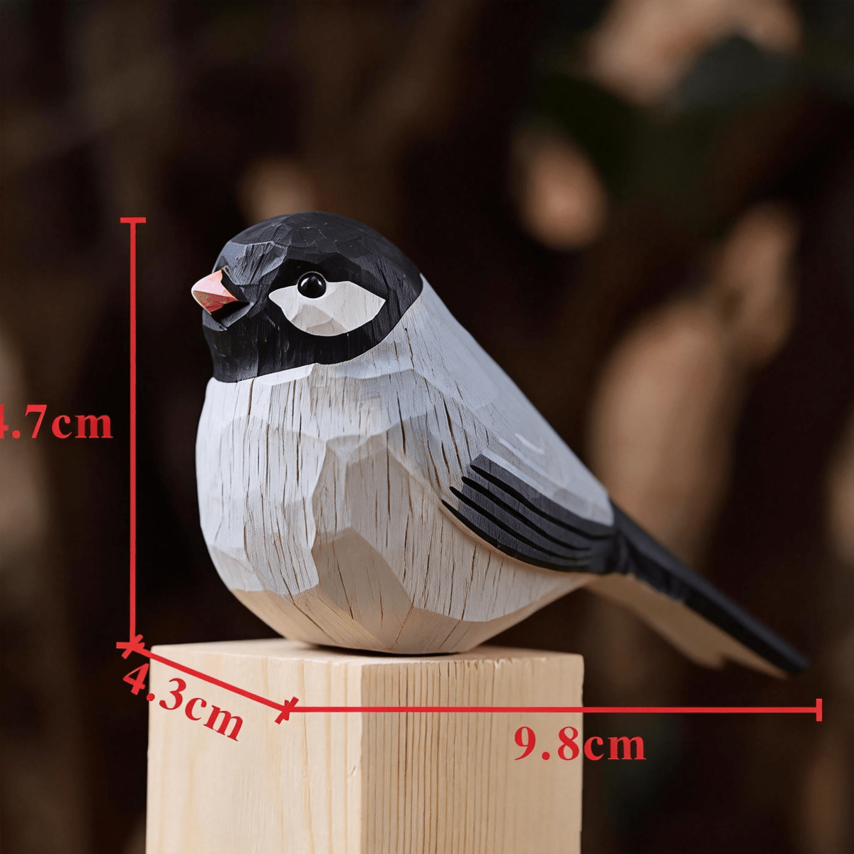 A detailed wooden wooden swallow carving dimensions on a wooden pedestal, showcasing intricate carvings and dimensions of 4.3cm in width, 4.7cm in height, and 9.8cm in length.
