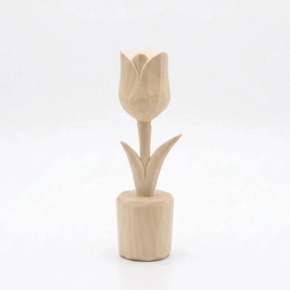 A carved wooden tulip figurine with a smooth finish and detailed petals.